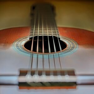 Artistic close-up of a classic acoustic guitar showing strings and soundhole.